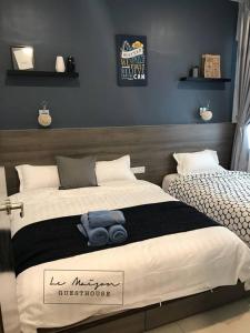 a bedroom with a bed with a blue towel on it at Le Maison GuestHouse @ Majestic Imperial in Ipoh