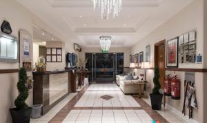 a living room with a lobby with a chandelier at Best Western Homestead Court Hotel in Welwyn Garden City