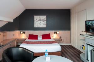 Un ou plusieurs lits dans un hébergement de l'établissement Brit Hotel Belfort Centre-Le Boreal