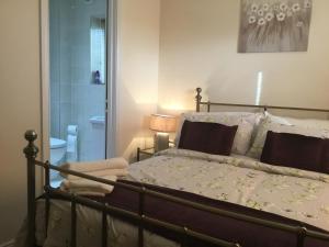 a bedroom with a bed and a bathroom at The Sidings in Enniskillen