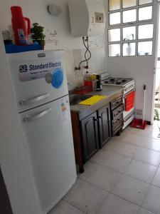 a kitchen with a white refrigerator and a stove at departamento centro in La Rioja
