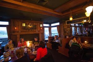 a group of people sitting at tables in a restaurant at McMenamins Gearhart Hotel in Gearhart