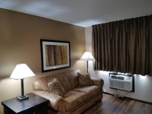 a living room with a couch and a window at Americas Best Value Inn and Suites Bismarck in Bismarck