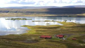 an island in the middle of a large body of water at Vestmannsvatn Guesthouse in Aðaldalur