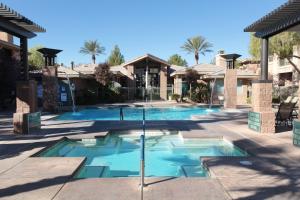 a swimming pool with a fountain in a yard at The Cliffs at Peace Canyon in Las Vegas