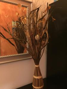a vase with flowers in it next to a painting at Vienna Top Comfort Apartment in Vienna