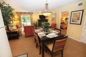 a dining room and living room with a table and chairs at Vacation Village at Williamsburg in Williamsburg