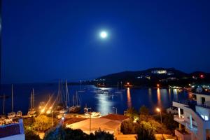 a view of a marina at night with the moon at Doada Hotel in Datca