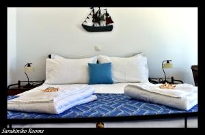 a bedroom with a bed with two towels on it at Sarakiniko Rooms in Adamantas