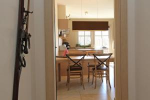 a kitchen with a table and chairs and a kitchen with a window at AvenidA Residenz an der Burg by Alpin Rentals in Kaprun