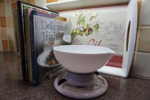 a white bowl sitting on a counter next to books at Dromore Court in Warrenpoint