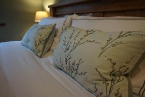 a bed with two pillows and a blanket at Dromore Court in Warrenpoint