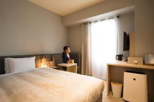 Postel nebo postele na pokoji v ubytování HOTEL FUKURACIA OSAKA-BAY