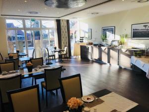 a restaurant with tables and chairs in a room at Gasthof Robben in Twist