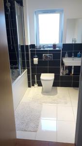 a bathroom with a toilet and a sink at Lavi's house-East Milton Keynes in Milton Keynes +19 photos