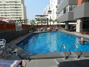 a swimming pool on the roof of a building at Nanatai Suites in Bangkok