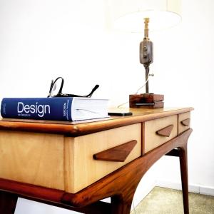 a desk with a book and a lamp on it at Viver Bahia Pousada in Salvador