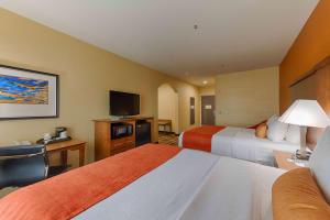 a hotel room with two beds and a flat screen tv at Best Western Plus Delta Inn & Suites in Oakley