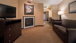 a living room with a couch and a fireplace at Best Western of Alexandria Inn & Suites & Conference Center in Alexandria
