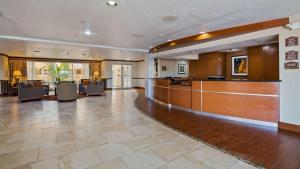 a large lobby with a reception desk and chairs at Best Western Plus Atrium Inn in Schertz