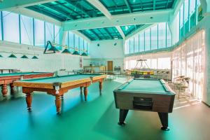 a large room with billiard tables in it at Ivushka Health Resort in Loo