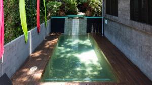 a small pool of water on a wooden deck at CELADON Holiday House in Palm Cove