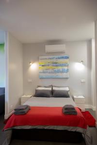 sypialnia z dużym łóżkiem i czerwonym kocem w obiekcie WindRose 1 w Madrycie