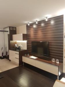 a living room with a large flat screen tv at Apartament Baltic Marea in Międzyzdroje