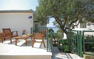 a patio with two chairs and a table and a tree at Apartment MIVA in Brela