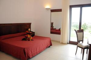 Postel nebo postele na pokoji v ubytování Agri Hotel Conte Salentino + 32 fotografií