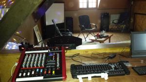 a recording studio with two keyboards and a monitor at Le Curieux de Conques in Saint-Cyprien-sur-Dourdou