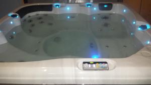 a white bath tub with a remote control in it at Le Curieux de Conques in Saint-Cyprien-sur-Dourdou +118 photos