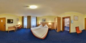 Postel nebo postele na pokoji v ubytování Hotel Windsor