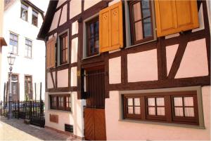 a building with wooden doors and windows on a street at Ferienhaus Gloecknerhaus in Michelstadt
