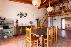 a dining room with a wooden table and chairs at Can Juan Pedro in La Mola
