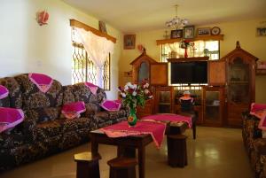 a living room with a couch and a table at Shimbwe Meadows Home in Moshi