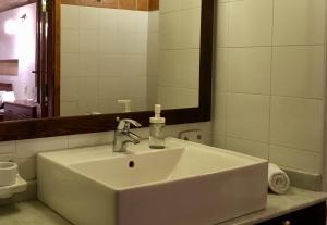 a white sink in a bathroom with a mirror at Xemx in Qala