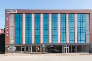 an office building with a large glass facade at Goldhan Hotel in Tekirdag