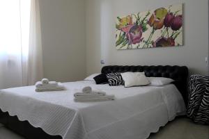 トッリ・デル・ベーナコにあるA Casa di Emy, Lago di Gardaのベッドルーム1室(ベッド1台、タオル2枚付)