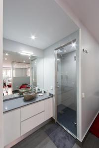 W łazience znajduje się umywalka i przeszklony prysznic. w obiekcie WindRose 4 w Madrycie