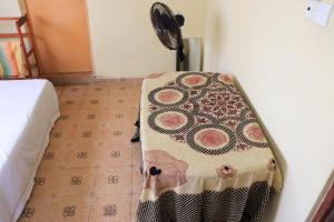 a table with a blanket on it in a room at Sunshine Guest in Madihe East