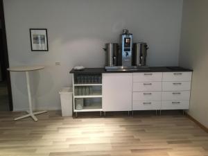 a kitchen with a refrigerator and a counter top at P-Hotels Oslo in Oslo