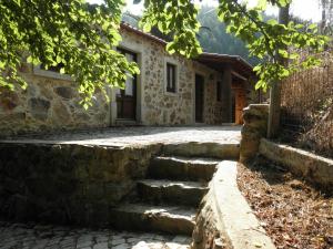 a stone house with stairs in front of it at Casa Velha in Figueiró dos Vinhos