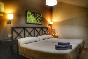 Postel nebo postele na pokoji v ubytování Apartamentos Alcazar de Baeza