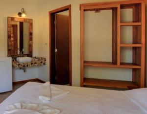 Cama ou camas em um quarto em Pousada Tupinamba