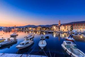 a group of boats docked in a harbor at night at Apartman Mir in Kaštela