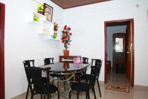 a dining room with a table and chairs at Spice Valley Home Stay & Tree House Munnar in Munnar