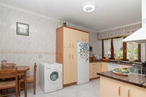 a kitchen with a refrigerator and a washing machine at Villa Ruben in Miengo