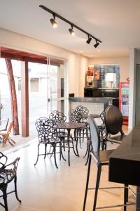 a group of chairs and tables in a room at Hotel Marina Torrano in Trindade