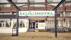 a building with a sign that reads be forhibited at Belfort Hotel in Amsterdam